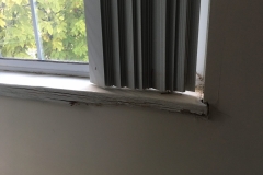 Moisture has caused window sill to expand and rot